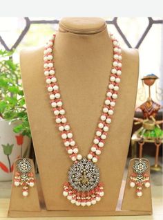 Temple Jewelry necklace of Pearl and Beads with matching earrings Perfect for any kind of occasions and ceremonies. You can wear it with Saree lehenga and Evening Gowns. Highest quality and craftsmanship. Arrives in box Please let me know if you have any questions Pearl Beaded Jewelry For Receptions, Pearl Beaded Jewelry For Reception, Long Pearl Necklace For Wedding And Festivals, White Jewelry Sets With Pearl Chain For Celebration, White Temple Jewelry Necklace For Wedding, Long Pearl Embellished Necklace For Weddings, Elegant White Beaded Necklaces For Reception, Wedding Long Pearl Necklace, Temple Jewelry Style Pearl Pendant Necklace For Wedding