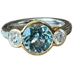 A timeless 18 K white Gold and rose Gold three Stone Ring featuring a bezel set Aquamarine wewighing approximately 2.50 ct. The centre stone is flanked by 2 bezel set brilliant cut Diamonds weighing 0.84 ct, G color, vs clarity. The ring size is currently a swiss 53/13 American Ring size 6 1/2, but can easily be resized. The ring is stamped with makers mark and 750. Masterfully handcrafted piece! Authenticity and money back is guaranteed. For any enquires, please contact the seller through the m Luxury Three Stone Gemstones For Anniversary, Bezel Set Diamond Gemstones, Round Diamond Gemstones With Bezel Setting, Luxury Bezel Set Gemstones For Formal Occasions, Luxury Formal Gemstones With Bezel Setting, Luxury Gemstones With Bezel Setting For Formal Occasions, Anniversary Gemstones With Bezel Setting In Fine Jewelry Style, Anniversary Fine Jewelry Gemstones With Bezel Setting, Anniversary Gemstones With Bezel Setting