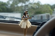 a doll is sitting on the dashboard of a car