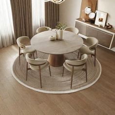 a round dining table surrounded by beige chairs