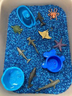 there are many toys in the sand and water play set for toddlers to play with