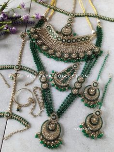 Complete Emerald green bridal set for Indian Pakistani weddings with beautiful champagne stones. Plating is antique gold. Superior craftsmanship. Each and every piece in this set has been made with utmost care and perfection. This complete bridal set includes: - Choker Necklace - Long Necklace (Length-40cm) - Earrings (Length-7.5cm; Width-4.5cm; Weight-30gm each) - Mathapatti  - Pasa / Side Tikka - Nose Ring / Nath (Weight-18gm) - Hathphool / Hathpanja / Hand Jewelry / Hand Harness All our sets Side Tikka, Green Wedding Jewelry, South Asian Jewelry, Bridal Jewelry Sets Brides, Pakistani Brides, Hand Harness, Sparkling Champagne, Jewelry Pakistani, Asian Jewelry