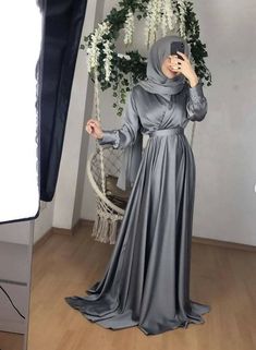 Exclusive modest gown crafted in premium Satin silk for quality & durability.It features a tie neckline for elegance,concealed& back zipper closure.fit & flare silhouette This beautiful gown wont disappoint. Model is wearing S in Grey.Hijab will not be matching as the materials will be different!Final sales No exchanges No refunds. In case of a defect, please make an open parcel video! *No claim will be entertained without an open parcel video!** Ivory white maybe see through match it with our s Wedding Dresses For Eid, Elegant Solid Color Dresses For Eid, Elegant Satin Maxi Abaya, Eid Satin Maxi Dress, Elegant Solid Color Wedding Abaya, Modest Formal Maxi Dress For Eid, Modest Fitted Abaya For Wedding, Modest Fitted Floor-length Abaya, Fitted Solid Maxi Length Abaya