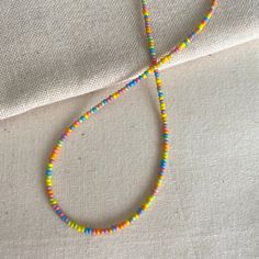 These bright necklaces are made with rainbow seed beads in a randomized pattern, meaning each is unique. They are very dainty and can add a fun but subtle touch to your outfits! Each is handmade with love :) Necklace Length: This necklace is available in lengths of 14, 15, 16, and 18 and inches. If you would like me to add an extender chain on the end of the necklace, please let me know in the personalization box! Note on shipping: The standard shipping for domestic orders is through oversized l Bright Necklace, Pattern Meaning, Diy Friendship Bracelets Tutorial, Bracelets Tutorial, Diy Friendship Bracelets, Friendship Bracelets Tutorial, Recycling Ideas, Random Pattern, Bead Choker