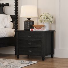 a night stand with two drawers and a lamp on the end table next to it