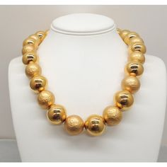 This is part of Chairish’s Costume Jewelry assortment.  Goldtone large smooth and "hammered" goldtone bead single strand necklace with hook clasp. Marked "Napier" on the hook. Dates to 1992. Interior circumference about 20 1/4 inches at the largest setting. Beads are 3/4 inches across. Overall measures: 8 inches long by 5 3/4 inches wide. Condition: Very good; light surface wear to some of the beads. The matching charm bracelet (which I'm also selling) is shown on pg. 685 of Melinda L. Lewis & H Classic Gold Necklace With Faceted Beads, Gold Necklaces With Large Beads For Formal Occasions, Formal Gold Necklaces With Large Beads, Formal Gold Necklace With Large Beads, Formal Gold Beaded Necklace With Faceted Beads, Formal Gold Necklaces With Faceted Beads, Gold Jewelry With Faceted Beads For Formal Occasions, Formal Gold Jewelry With Faceted Beads, Hook Clasp