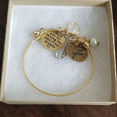 a bracelet with two charms in a box