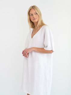 "PEONY is a loose fitting v-neck linen midi dress. DETAILS - Knee length - Kaftan silhouette - Short sleeve - V neckline - Pockets available upon request - Oeko-Tex certified 100% lightweight linen - Cut and sewn to order just for you in our studio COLOR - White, you can also choose other colors above - Fabric samples are available here https://www.etsy.com/listing/586569696/linen-fabric-samples SIZING & FIT - Fits true to size - Length (shoulder to hem) is approximately 37.5 inches / 95 cm V-neck Linen Dress For The Beach, Oversized V-neck Midi Dress For Daywear, Linen V-neck Tunic For Summer, Linen V-neck Tunic For Daywear, V-neck Unlined Linen Beach Dress, White Linen V-neck Casual Dress, White Linen V-neck Midi Dress, White Casual Linen V-neck Dress, Casual White Linen V-neck Dress