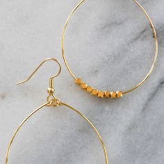 These big beaded hoops in gold or silver are the perfect simple statement — just right for those busy mornings when finding something that matches your outfit is just too much to ask. stainless steel ear wire and hand-shaped hoop with faceted beads choose gold-plated or silver-plated lead-free and nickel-free plastic earring back 2.5" long and 1.5" wide (each pair is handmade so sizes can vary slightly) packaged on a kraft earring card in a clear resealing bag Hoop Earrings Big, Gifts For Girlfriends, Earrings Gold Hoops, Earring Card, Plastic Earrings, Earrings Big, Earring Cards, Beaded Hoop Earrings, Beaded Hoops