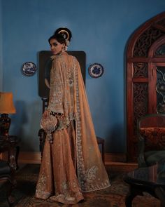 Buy Pakistani Wedding Dress in Sharara Kameez Dupatta Style, a breathtaking masterpiece adorned with hand-crafted details of pearls, tilla, and silverwork. Elegant Semi-stitched Wedding Dress With Traditional Drape, Anarkali Hand Embellished Organza Wedding Dress, Gold Lehenga With Pearl Embroidery For Wedding, Designer Wedding Dress With Resham Embroidery For Eid, Elegant Saree Wedding Dress With Dupatta, Gold Wedding Dress With Dabka Work, Festive Hand Embellished Wedding Dress, Wedding Salwar Kameez With Intricate Kundan Embroidery, Bollywood Style Floor-length Hand Embellished Wedding Dress