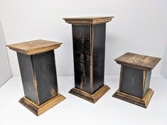 three wooden pedestals sitting next to each other