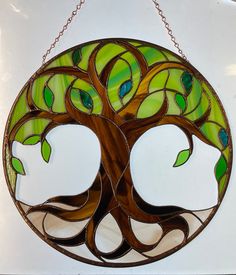 a stained glass tree hanging from a chain