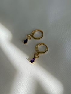 "18K gold plated teardrop amethyst, emerald drops huggie hoops which are beautifully shiny under the sunlight. *Nickel free 👀 Details 👀 * Materials : 18K gold plated brass, Amethyst, Emerald * Hoop style * 10mm hoop diameter (Inner diameter : 8mm) Crystal charm : 3 mm (w) x 6 mm (h) * Product is non-returnable for hygiene ⚠️Tips for caring⚠️ -Keep jewelry dry (Avoid contact liquid) -Store difference type of jewelry separately -Store jewelry in a small zip lock bag 📦 Packaging 📦 These earring Gold Plated Teardrop Huggie Earrings, Tarnish Resistant Teardrop 14k Gold Filled Huggie Earrings, Gold Plated Teardrop Earrings For Gift, Elegant Gold Amethyst Hoop Earrings, Anniversary Gold Plated Teardrop Huggie Earrings, Anniversary Teardrop Gold Plated Huggie Earrings, Anniversary Teardrop Gold-plated Huggie Earrings, Gemstone Dangle Huggie Earrings Gift, Gold Plated Dangle Huggie Earrings For Gift