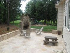 a patio with chairs and a fire place