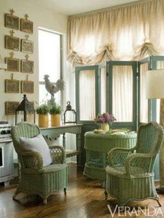 a living room with wicker furniture and green curtains on the window sill, along with a white stove top oven