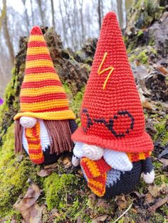 two crocheted gnomes are sitting on the ground