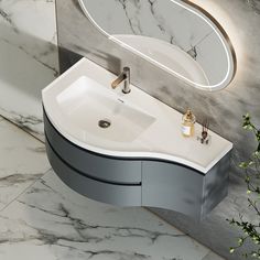 a bathroom sink sitting under a mirror next to a plant