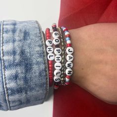 These Philadelphia Phillies themed beaded bracelets come in red, blue, or white and can say a variety of Phillies phrases or customize it to say something else! These bracelets are perfect for any Philly lovin gal or guy.  Please select size and style options in the personalization box. This bracelet is stretchy and made for the average-sized adult, if you need it to be larger or smaller please specify the size in inches in the notes section when purchasing.  IF you would like this style bracelet to say something else, check out our other listing below. https://www.etsy.com/listing/773122283/customized-name-bracelet?ref=shop_home_active_4  Feel free to reach out with any other questions or concerns! **Not recommended for children under 4 years old ** Red Casual Letter Beads Jewelry, Phillies Bracelet, Swiftie Bracelets, Heart Glasses, Creating Jewelry, Name Bracelet, Philadelphia Phillies, Bead Bracelets, Pretzels