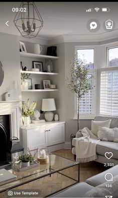 a living room filled with furniture and a fire place in front of a tv mounted on a wall