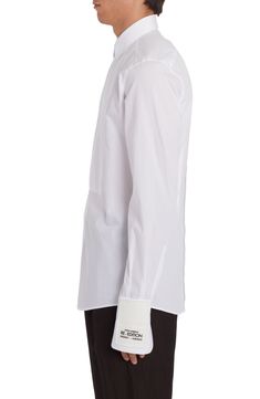 From the label's 'Re-Edition' collection comes this cotton-poplin shirt that features a partially hidden placket and a tuxedo-style bib. 31" length; 38" chest (size Medium) Front button closure Point collar Long sleeves with two-button cuffs 100% cotton Dry clean Made in Italy Men's Designer Clothing Designer White Shirt With Concealed Placket, Elegant Long Sleeve Poplin Top, Elegant White Poplin Shirt, Luxury White Shirt With Concealed Placket, Elegant Poplin Shirt For Spring, Formal White Poplin Tops, Elegant Spring Poplin Shirt, Elegant Poplin Tops With Spread Collar, Elegant Poplin Top With Spread Collar