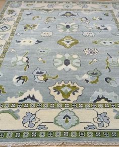 a blue rug with green and white designs on it