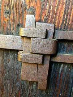 an old wooden door with metal latch on it