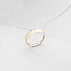 The Minimalist Dome Ring has an elegant design that its plainness is the modesty which will fascinate people around you. It is perfect for everyday use and ring stacking. - Made in 14k Solid Gold - Top Width: 4.10 mm / 0.16 inches - Thickness: 0.86 mm / 0.03 inches- Bottom Width: 2.53 mm / 0.09 inches - This product comes with iconic Norm Jewels gift box Modern 14k Gold Stackable Rings, Modern 14k Gold Stackable Round Band Rings, Modern 14k Gold Stackable Rings With Round Band, 14k Gold Rings With Smooth Round Band, Minimalist 14k Gold Dome Ring For Wedding, Elegant Slim Band Stackable Signet Ring, Elegant Everyday Dome Ring With Round Band, Classic 14k Gold Toe Ring, Minimalist Jewelry With Polished Rounded Finish