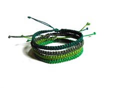 three bracelets with green and gray beads