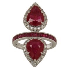 This exclusive ruby and diamond ring was made with the finest quality materials, to ensure that it is both elegant and durable. This beautiful stone set in 18K white gold showcases with two pear cut natural untreated ruby of the finest quality. Set with 0.46 carats of white round diamonds, this exquisite ring is sure to add elegance to any occasion. It weighs 6.95 grams and has a total gem weight of 5.09 carats for a stunning play on color and shape! It's truly a masterpiece of luxury that every Luxury Ruby Rings With Diamond Accents, Luxury Pear-shaped Ruby Ring, Luxury Diamond Ring With Lab-created Ruby Accents, Luxury Ruby Diamond Ring With Accent Stones, Gia Certified Ruby Ring, Luxury Red Rings With Diamond Accents, Fine Jewelry Pear-shaped Ruby Ring With Diamond, Luxury Brilliant Cut Lab-created Ruby Ring, Luxury Ruby Anniversary Ring