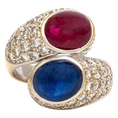 Ring finely crafted in 18K white gold with Cabochon Ruby and Sapphire surrounded with diamonds. The Cabochon Sapphire weighing approximately 4.00 carat. The Cabochon Ruby weighing approximately 4.00 carat. The diamonds weighing approximately 3.20 carat. The ring size is 6.5 US and 53 EU. Luxury Fine Jewelry Ruby Ring With Cabochon, Luxury Diamond Cabochon Gemstones, Luxury Diamond Gemstones With Cabochon Cut, Fine Jewelry Sapphire Cabochon Ring With Diamonds, Elegant Sapphire And Diamond Ring With Cabochon Cut, Elegant Sapphire Ring With Cabochon Diamond, Luxury Oval Cabochon Diamond Gemstones, Luxury Cabochon Diamond Ring For Formal Occasions, Luxury Diamond Cabochons For Wedding