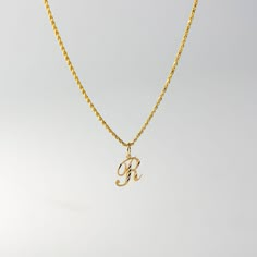 A timeless piece that will never go out of style. This 14K gold calligraphy pendant is the perfect and most stunning way of keeping a name close to your heart. We handmade each piece so you can assure you're getting a one-of-a-kind pendant that is not like any other. This 14K solid gold letter pendant is flawlessly crafted to look super chic and elegant around your neck. Pair it with a nice gold chain and wear it with almost all of your outfits. The piece is such a versatile lettering necklace. Custom Yellow Gold Initials Pendant Necklace, Anniversary Rope Chain Pendant Necklace, Anniversary Pendant Necklace With Rope Chain, Yellow Gold Initial Pendant Necklace, Yellow Gold Initials Pendant Necklace, Gold Initial Pendant Necklace, R Necklace, Gold Letter Pendants, R Initial