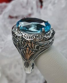 Simulated Aquamarine Ring Description Lion Design#218 MADE TO ORDER I now offer this is a brand new Art Deco/Victorian reproduction ring in solid sterling silver. The gorgeous filigree ring is set with a simulated Aquamarine. The high-quality round cut Aquamarine is 16mm by 12mm. The inside of the band is marked 925 for sterling. Notice the beautiful craftsmanship of the silver filigree setting. Feel free to ask questions and thanks for looking at my auctions. All rings can be sized by any jewel Victorian Oval Engraved Ring, Victorian Engraved Oval Ring, Heirloom Oval Engraved Ring With Intricate Design, Victorian Oval Filigree Ring With Intricate Design, Oval Filigree Ring With Intricate Design For Collectors, Victorian Filigree Ring With Intricate Design, Oval Sapphire Rings For Jewelry Making, Victorian Blue Topaz Ring, Ornate Oval Engraved Ring With Intricate Design