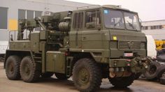 an army truck parked in front of a building