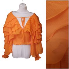 This Is A Ruffle Top With Tons Of Personality. The Material Is Sheer, But Added To The Elastic Base At The Torso And Cuffs Makes Those Areas Opaque. There Are Layers Of Sheer Ruffles Across The Shoulders And Arms. There Is A Very Deep Vneck That Is Secured With A Tie At The Chest. Great As A Summer Top Or As A Decorative Topper To A Dress. I Make Deals On All Bundles! Due To Nuances In Lighting, Camera Capabilities, And Viewing Screens, Colors May Be Different Than They Appear. Please Check Meas Spring Night Out Blouse With Ruffle Hem, Spring Ruffle Hem Blouse For Night Out, V-neck Ruffle Blouse For Night Out, Spring V-neck Peasant Top With Ruffles, Fitted Blouse With Ruffled Collar For Summer, Fitted Summer Blouse With Ruffle Sleeves, Fitted Blouse With Ruffle Sleeves For Summer, Trendy Party Blouse With Ruffle Hem, V-neck Ruffled Blouse For Night Out