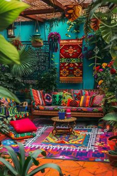 an outdoor area with colorful rugs and plants