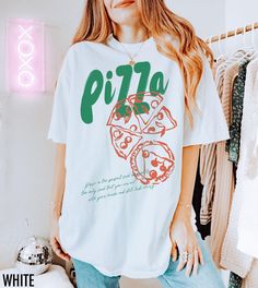 Satisfy your style cravings with this vintage-inspired Pizza tee! Featuring a bold pizza graphic this shirt adds a slice of retro fun to any casual look. The text at the bottom reads, " Pizza is the perfect food because it is the only food that you can eat with your hands and still look classy."  We use professional quality DGT printing on all our apparel. Direct-to-garment, or DTG, is a high quality printing method that sprays ink directly onto the garment so there is no peeling or cracking. Th Retro White Print Crew Neck T-shirt, Grunge Crew Neck T-shirt With Funny Print, Retro White T-shirt With Funny Print, Retro White Print Short Sleeve T-shirt, Vintage Text Print Crew Neck Shirt, Retro White Print Tops For Streetwear, Retro White T-shirt With Letter Print, Retro White Letter Print T-shirt, Trendy White Print Short Sleeve T-shirt