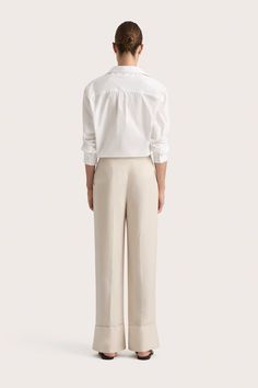 A mid-rise suit trouser, crafted from a Linen blend fabrication in a neutral hue. They are designed with a full-length straight leg and cuffed hem detail. Pair with a classic button up like the Alliste Shirt or the matching Soleil Blazer for a refined yet relaxed approach to suiting. Tailored Linen Classic Pantsuit, Classic Linen Pantsuit For Formal Occasions, Elegant Beige Wide Leg Pants With Straight Hem, Straight Hem Pants With Button Closure For Work, Classic Wide-leg Pantsuit, Classic Workwear Bottoms With Button Cuffs, Beige Straight Hem Pants For Office, Tailored Pants With Button Cuffs For Work, Tailored Linen Wide Leg Pants For Business Casual