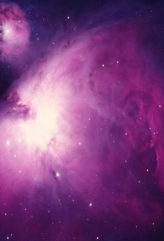 the large magentaic cloud in the sky is surrounded by stars and bright purple hues