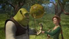 an animated character is handing something to a woman in a green dress and headband