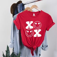 "XOXO Smile Shirt, Valentines Day Shirt, XOXO Valentines Day Shirt, Valentines Day Gift, Gift For Her, Cute Kisses Shirt, Valentine Kiss ---How To Order --- 1-) Please, check and review all photos 2-) Choose your t-shirt size and color 3-) Write your font color in personalization box 4-) Click add to cart. You can go back to add more product 5-)Click \"Proceed to check out\" 6-)When you check out, you can add a note to seller for any request SIZE AND COLORS: For sizing details and color options, Playful Crew Neck T-shirt For Valentine's Day, Playful Valentine's Day Crew Neck T-shirt, Cute Kiss, Playful Pink T-shirt For Valentine's Day, Casual Valentine's Day T-shirt With Heart Graphic, Heart Shaped Graphic T-shirt For Valentine's Day, Clean Cotton, Valentines Day Shirts, Sheer Fabrics