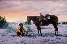 a man kneeling down next to a horse in the snow with a dog on his lap