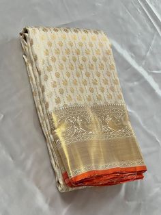 Bridal Collection White Color Pure Kanchipuram Silk Saree | Indian Traditional Ethnic Saree | Wedding or Party Wear Saree | Handwoven Gift Saree for Her Product Details : Saree Type : Pure Kanchipuram Silk Saree Golden Zari, Silk Mark Certified Blouse Piece : Yes (Un-Stitched) Saree Length : 5.5 Meters Blouse Piece Length : 80 cm Saree Weight : 0.9 kg Saree Fabric : Pure Kanchipuram Silk  Color : As shown in the picture Work : weaving Pattern : designer Occasion: Party Wear, Formal Wear, Festiva Festive Ceremonial Pre-draped Saree With Cutdana, Traditional Ceremonial Pre-draped Saree With Cutdana, White Pre-draped Saree With Self Design, White Cutdana Pre-draped Saree For Puja, Traditional Gold Pre-draped Saree With Motifs, Traditional White Pre-draped Saree With Zari Work, Traditional Pre-draped Cream Saree, White Katan Silk Pre-draped Saree With Pallu, Traditional White Pre-draped Saree With Self Design