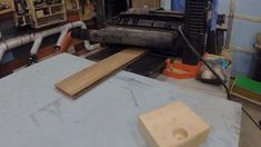 there is a large machine in the middle of making wooden planks and plywood