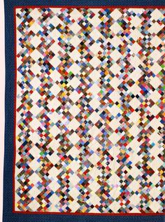 a blue and white quilt with many squares on it, all in different colors or shapes