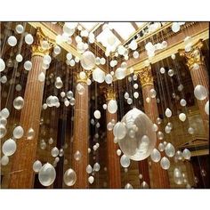 bubbles are floating in the air near columns