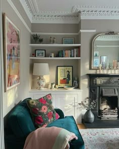 a living room filled with furniture and a fire place next to a mirror on the wall