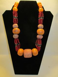 *Special Price* Antique Healing Stones, Sacred Amber, and Juju Beaded necklace.  A sacred necklace for that very special person. This antique necklace was created over 30 years ago by the renowned artist Ife East.  One of a Kind! 14 Amber beads 7 Rare Earth Stones Juju Beads Artisan Single Strand Orange Beaded Necklace, Artisan Polished Beads For Gifts, Artisan Jewelry With Large Oval Beads, Ceremonial Multicolor Large Beads Jewelry, Traditional Orange Single Strand Jewelry, Spiritual Amber Polished Beads Jewelry, Amulet Necklaces With Large Oval Beads, Unique Hand-strung Orange Necklace, Ceremonial Multicolor Large Beads Necklace