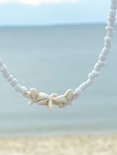 Cheap Handmade Choker For Beach, White Shell Choker Necklace For Summer, White Starfish Jewelry For Vacation, Handmade White Choker For Vacation, Adjustable White Choker For Festival, White Starfish Necklace For Summer, White Starfish Jewelry For Summer, Adjustable Starfish Necklaces For Summer, White Strand Choker As A Gift