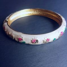 White enamel clasp bracelet bangle NEW. Pretty floral white enamel painted bangle with gold tone trim. Painted with pink and green flowers. Clasp closure. Diameter = 2.4 inches. Jewelry Bracelets White Bangle Jewelry For Spring, White Bangle Bracelet For Spring, Adjustable White Vintage Bangle, Adjustable White Bangle, Pink And Green Flowers, Clasp Bracelet, Floral White, Bracelet Clasps, Bracelet Bangle