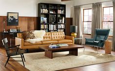 a living room filled with furniture and bookshelves